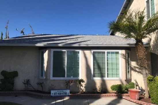 Beige stucco house front with palm tree
