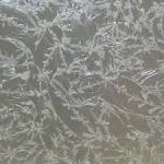 Feathery frost patterns on glass
